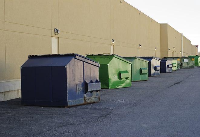 a row of industrial dumpsters at a construction site in Caledonia